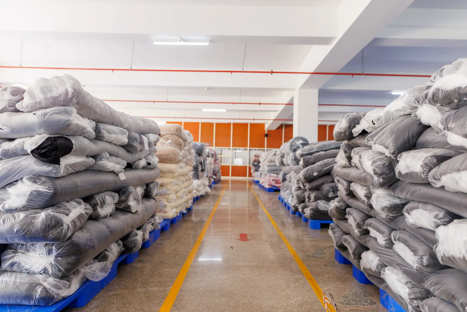 Material rolls stored for incoming inspection at Cossmo Tex
